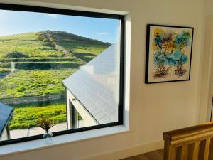 a window with a view of a solar panel at Greene Acres - Room Only in Doolin