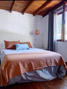 a bedroom with a bed in a room with a window at Cabañas Las Sirenas in Mar del Plata