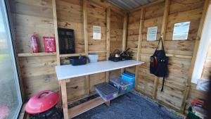 a inside of a wooden cabin with a counter in it at Calon Y Goedwig Glamping in Llandovery