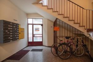 two bikes parked in a hallway with a staircase at Im Herzen von Wien - Charmante Garconiere in Vienna
