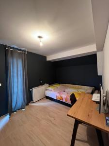 a bedroom with a bed and a desk and a table at Modern apartment in Skopje in Skopje