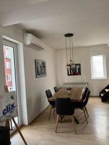 a dining room with a table and chairs at Modern apartment in Skopje in Skopje