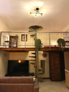 a living room with a loft bed and a couch at Romeo Apartment in Livorno