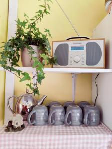 a shelf with a microwave on top of a table at Sherlock's House-Melbourne 4 rooms 8 beds Free Private parking Free super Wifi Working facility 42" smart TV in Burton upon Trent