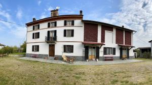 a large white house with a round roof at Monferrato Guest House - Casa Gabry in Bruno