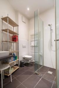 a bathroom with a toilet and a glass shower at Studententraum am Naschmarkt in Vienna