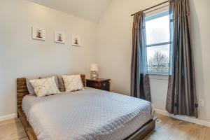 a bedroom with a bed and a large window at Modern Indianapolis Home Less Than 2 Mi to Downtown! in Indianapolis