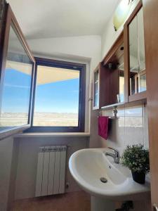 a bathroom with a sink and a large window at Bilocale vicino Aeroporto in San Giovanni Teatino