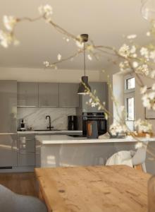 a kitchen with a wooden table and a kitchen counters at Haus 1 in Bosau