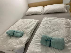 two beds with towels on them in a room at Brasilia apartment in Ljubljana