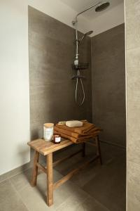 a shower with a wooden bench in a bathroom at Haus 1 in Bosau