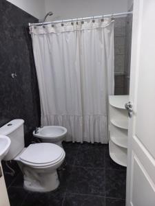 a bathroom with a toilet and a sink and a shower at Casa del sol in Cañada La Negra