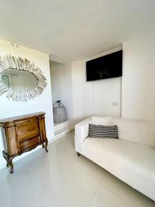 a living room with a couch and a mirror at Villa Kalypso - Porto Cervo in Porto Cervo