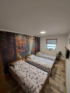 - 4 lits dans une chambre ornée d'une peinture murale dans l'établissement Luxury Apartment Zimska idila, à Bjelašnica