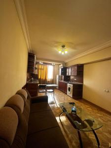 a living room with a couch and a table at Nice Apartment in Koghbaci Street in Yerevan