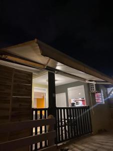 a porch with awning on a house at night at LASYMPHO - Séjour de repos à la campagne in Le François