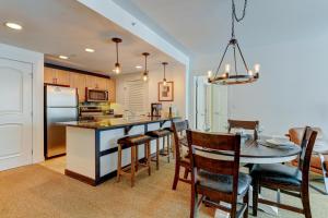 a kitchen and dining room with a table and chairs at Ski In-Out Luxury Condo #4283 With Huge Hot Tub & Great Views - 500 Dollars Of FREE Activities & Equipment Rentals Daily in Winter Park