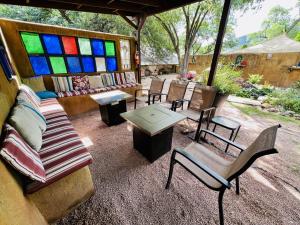 a patio with a couch and chairs and stained glass windows at Mile High Ranch in Bisbee