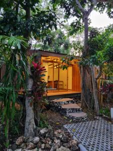 a house in the middle of a garden at Grün Resort Uluwatu in Uluwatu