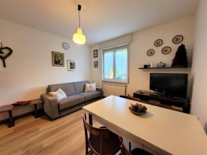 a living room with a couch and a table at Casa Mina Mountain Lake Iseo Hospitality in Bossico