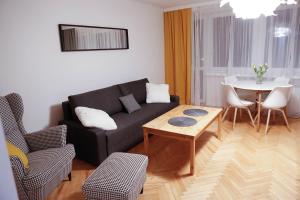 a living room with a couch and a table at To-Ten in Radom