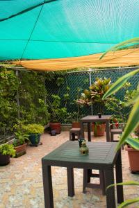 a patio with a table and some potted plants at Casa Irma in Guatemala