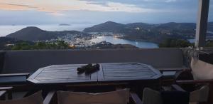 a table on a balcony with a view of a city at Patmos Chora traditional villa Genadio in Patmos