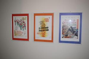 a row of four framed posters on a wall at MyVilla - Ivrea via Jervis 22b in Ivrea