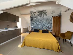 a bedroom with a yellow bed with a yellow blanket at Sweet Home SXM Baie Nettlé Pieds dans l'eau in Baie Nettle
