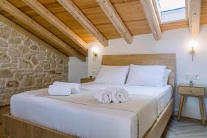 a bedroom with a bed with towels on it at Cambiello Bella Casa in Corfu Town