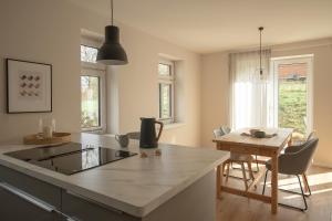 a kitchen and dining room with a table and chairs at Haus 1 in Bosau +13 photos