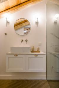 a bathroom with a white sink and a mirror at Cambiello Bella Casa in Corfu Town