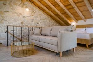 a living room with a couch and a bed at Cambiello Bella Casa in Corfu Town