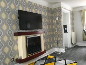 TV a/nebo společenská místnost v ubytování Highland Home