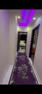 a hallway with a purple carpet with flowers on it at شارع مراد على النيل in Cairo