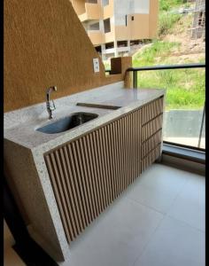 a bathroom with a sink and a window at Flat no melhor trecho de Carneiros in Praia dos Carneiros