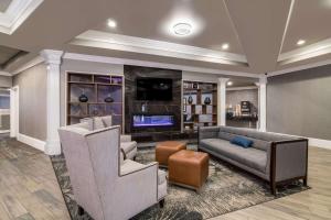 a living room with a couch and a tv at Comfort Inn & Suites Plattsburgh - Morrisonville in Plattsburgh