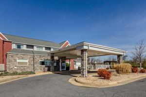 a large building with a covered parking lot at Clarion Pointe Staunton East in Staunton