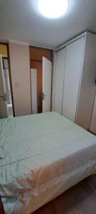 a bedroom with a large bed with a light on the ceiling at La Marta in Ciudad Lujan de Cuyo +4 photos