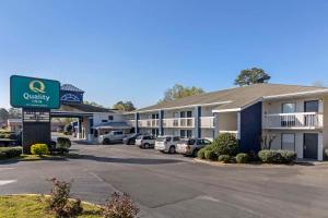 a hotel with cars parked in a parking lot at Quality Inn in Newberry