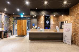 釜山Sorgente Business Hotel的砖墙和柜台的商店前