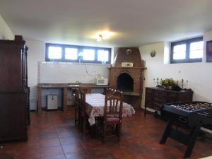 a living room with a table and a fireplace at Vivienda Sampedri in Santillana del Mar