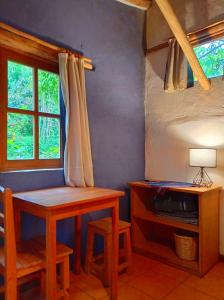 a room with a table and a desk and a window at La Selenita in Sucre