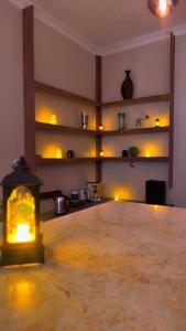 an empty room with a lit up room with a table at رواق الضيافة للشقق المخدومة RWAQ Hotel in Jazan