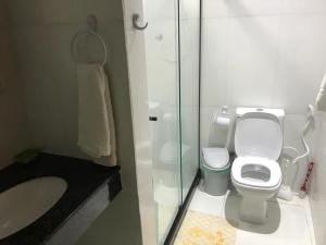 a bathroom with a toilet and a sink and a shower at CASA DA BARRA- Suítes privativas em Saquarema in Saquarema