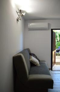 a couch sitting in a room with a window at Calma Kourouta Apartments in Kourouta