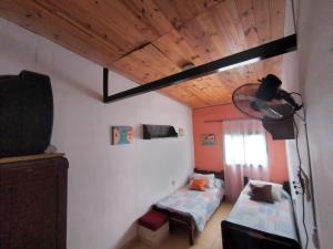 a room with two beds and a lamp in it at Carlina in Salta