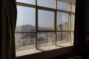a window with a view of a city at Al Rayyan Towers 4 in Makkah