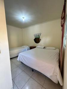 a bedroom with two beds in a room at Hostal y Restaurante Posada Real in La Palma