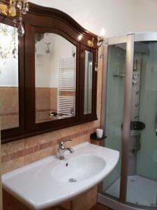 a bathroom with a sink and a mirror at L'Arca in Talsano +34 photos